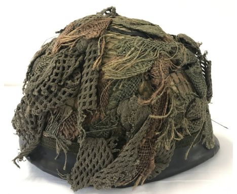 A Belgian Army OTAN M1951 steel helmet, US M1 style, circa 1985. With net and scrim. Liner complete with canvas suspension li