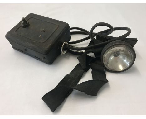 A British WWII Civil defence A.R.P. helmet lamp.  From a private collection.