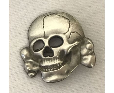 A WWII style Waffen SS Totenkopf visor skull badge.  