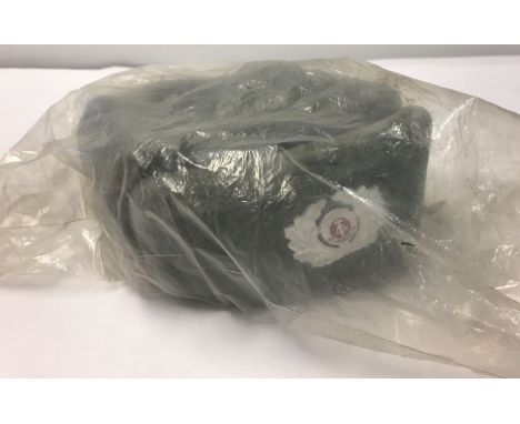 A Cold War East German Army cold weather hat with cap badge. Still sealed in original bag of issue. Size 54.