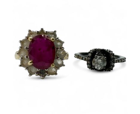 A 1/3 of a carat (estimated)salt and pepper diamond ring in a raised mount, with a black coating to the precious metal mount,