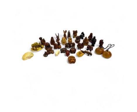 A collection of wooden, tagua and other Japanese netsuke, 19th century and later, including opening persimmon form examples, 