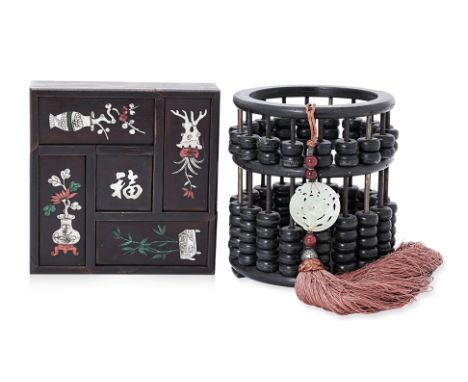 A CHINESE ABACUS AND AN INLAID PUZZLE BOX
The abacus of cylindrical form, the puzzle box with five covers each inlaid in moth