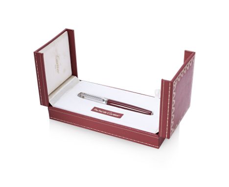 A PASHA DE CARTIER ROLLERBALL PEN
Burgundy lacquer barrel and silver plated cap with Cartier Trinity rings, signed 'Pasha de 