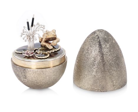 A STUART DEVLIN SILVER SURPRISE EGG
London 1982, No.28, with textured exterior, the interior with a frog sat on a lily pad
6c