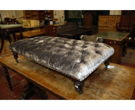 An upholstered centre stool, 19th century and later, the button upholstered rectangular top above four turned mahogany legs w
