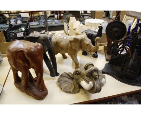 Four large wooden carved model elephants, an elephant gong, wall sconce and bracket 