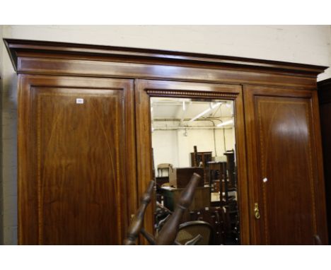 An Edwardian mahogany and inlaid triple wardrobe with central mirror door 210cm wide 