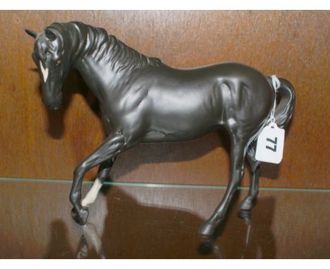 Beswick Pottery model of a black matt horse with white mark on nose and white front sock