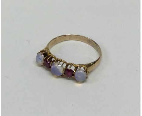 A ruby and opal five stone ring in 18 carat gold claw mount. Approx. 2.4 grams. Est. £50 - £80.