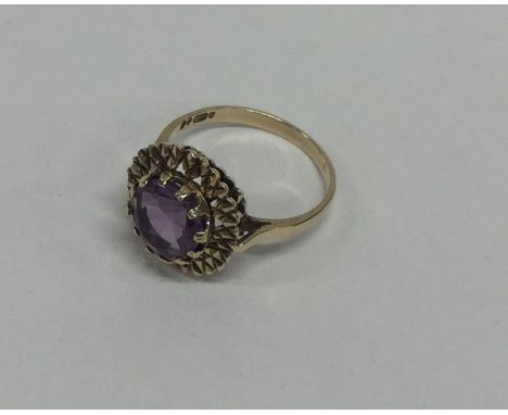 An amethyst single stone ring in claw mount. Approx. 3.6 grams. Est. £70 - £80.