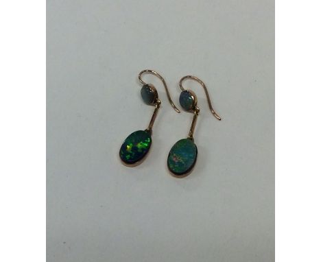 A pair of black opal doublet gold drop earrings. Approx. 1.7 grams. Est. £30 - £40.