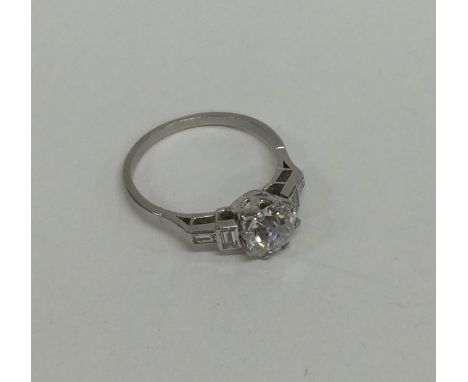 A good diamond single stone ring in Art Deco mount with baguette cut stones in platinum setting. Approx. 2 carats. Approx. 4.