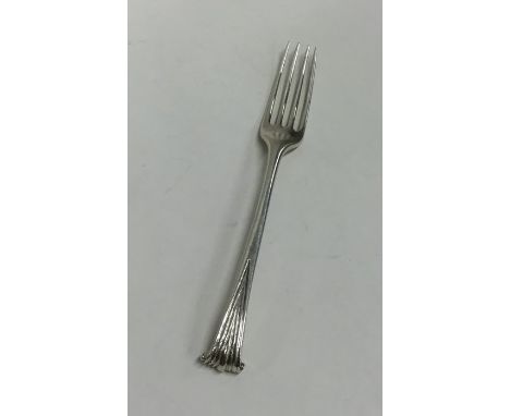 A Georgian silver fork with tapering scroll handle. Approx. 43 grams. Est. £30 - £40.