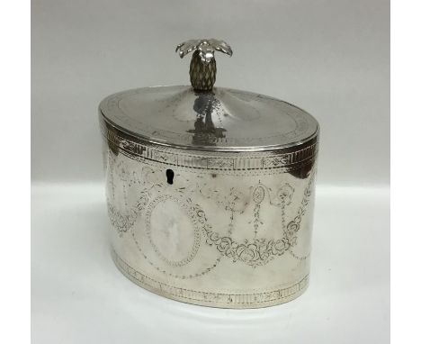 A good quality Georgian silver hinged top tea caddy decorated with swags and pineapple finial. London 1788. By Henry Chawner.