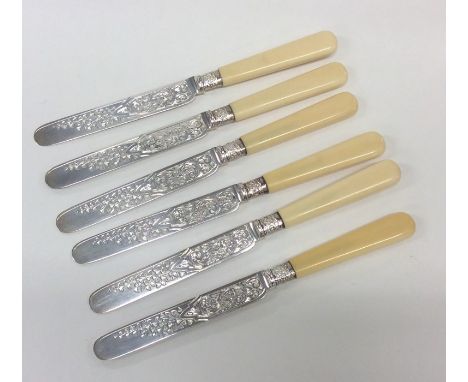 A set of six Edwardian silver engraved tea knives with tapering handles. Sheffield. By JR. Approx. 261 grams. Est. £50 - £80.