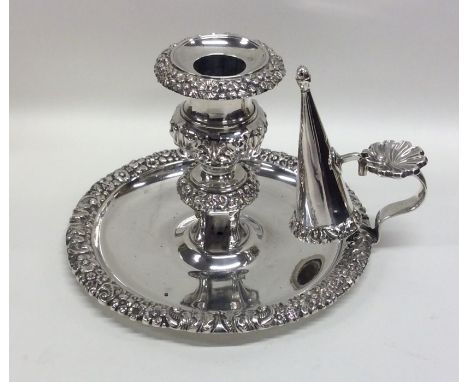 A circular Georgian silver chamber stick together with matching snuffer with floral cast border. London. By ITB. Approx. 384 