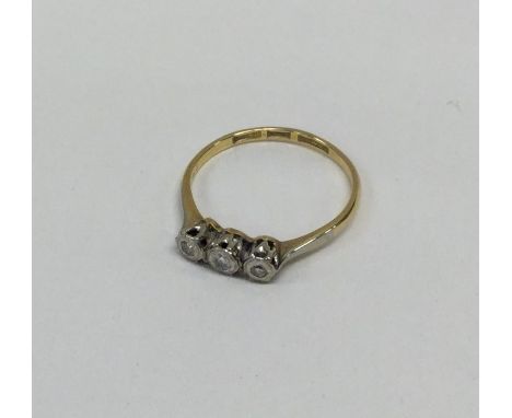 An 18 carat gold and platinum diamond three stone ring. Approx. 2 grams. Est. £30 - £40.