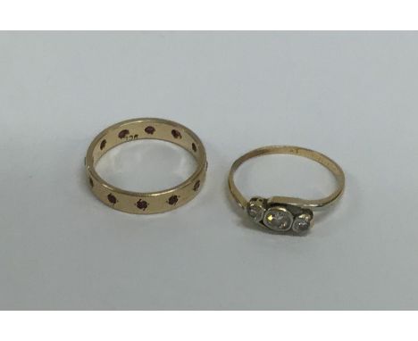 A small ruby wedding band together with a diamond crossover ring. Approx. 3.5 grams. Est. £35 - £45.