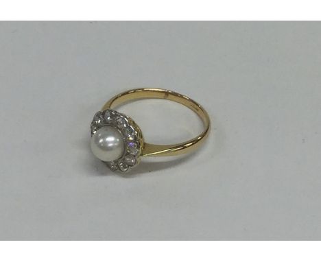 An attractive pearl and diamond daisy head cluster ring in 18 carat and platinum. Approx. 2.5 grams. Est. £350 - £450.