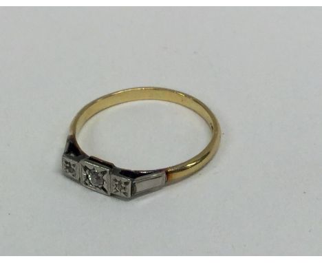 An 18 carat gold and platinum diamond set three stone ring. Approx. 2.6 grams. Est. £75 - £85.