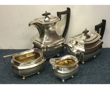 A heavy Georgian style four piece silver tea service. Sheffield. By Walker &amp; Hall. Approx. 2003 grams. Est. £500 - £800.
