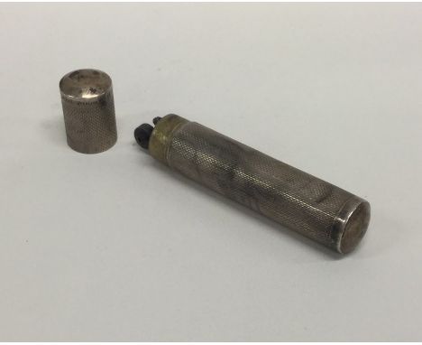 A silver engine turned cylindrical lighter. Approx. 21 grams. Est. £25 - £35.