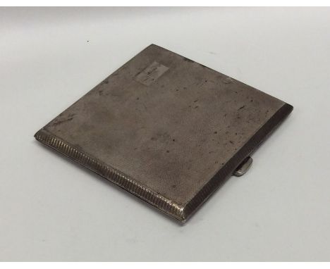 A heavy engine turned silver cigarette case. Birmingham. By WTT. Approx. 100 grams. Est. £25 - £35.