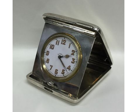 A heavy silver travelling clock. London. By R&amp;S. Approx. 424 grams. Est. £150 - £200.