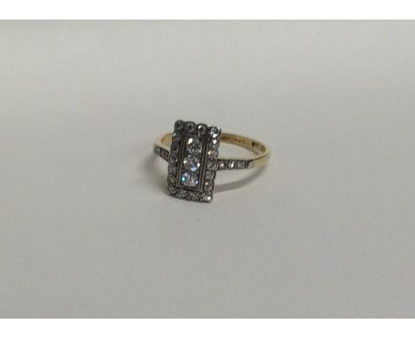 A good diamond rectangular cluster ring with matching shoulders to two colour gold. Approx. 3.1 grams. Est. £1200 - £1500.