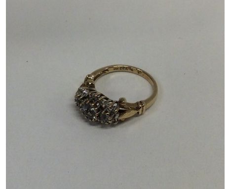 A diamond mounted triple cluster ring in 9 carat mount. Approx. 3.4 grams. Est. £30 - £40.