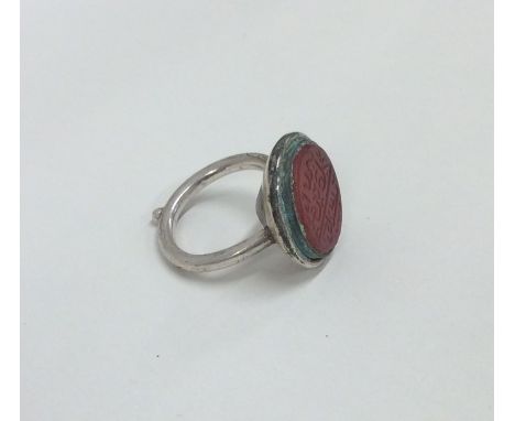 An unusual Islamic silver signet ring mounted with a hard stone and script. Approx. 9.5 grams. Est. £20 - £30.