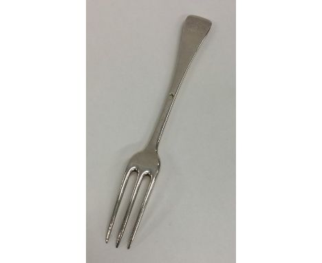A Georgian silver Hanoverian pattern three prong fork with crested terminal. Approx. 61 grams. Est. £45 - £55.