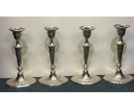 A good set of four silver Adams' style candlesticks on spreading bases with reeded borders. Sheffield. By JB&amp;K. Est. £250