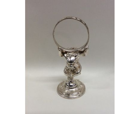 An unusual silver plated model of a mythical creature holding a ring. Est. £25 - £35.