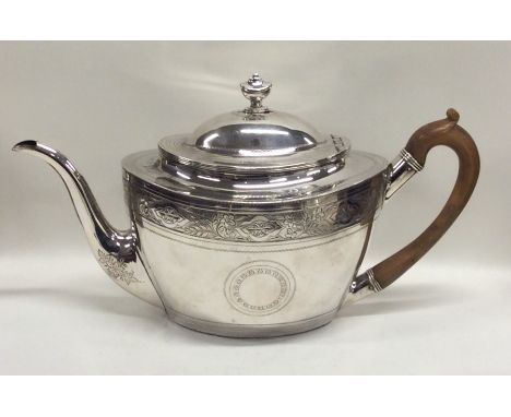 A good Georgian silver oval teapot decorated with flowers, leaves and wriggle work and vacant cartouche. London 1801. By DUMH