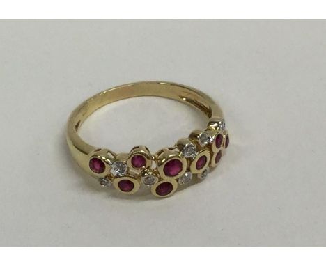 A ruby and diamond modernistic ring in rubover gold mount. Approx. 2.9 grams. Est. £30 - £40.