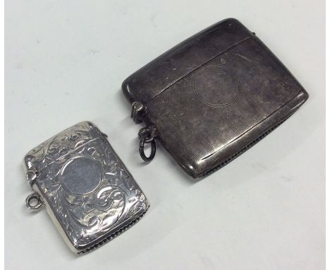 An attractive hinged top engraved silver vesta case together with an engine turned silver example. Approx. 45 grams. Est. £30