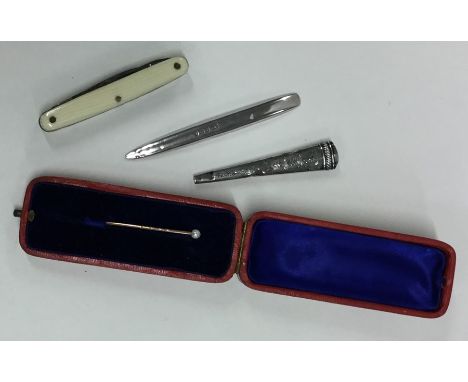 A silver mounted knife together with a pearl stick pin etc. Est. £20 - £30.