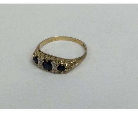 A sapphire and diamond seven stone ring in carved mount. Approx. 2 grams. Est. £25 - £35.