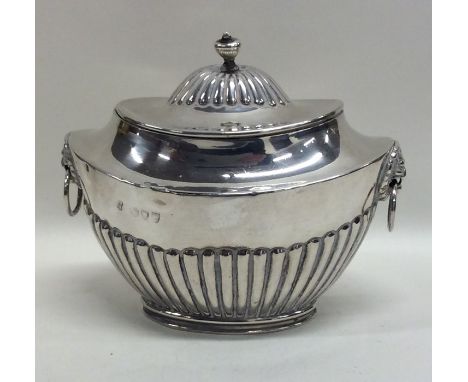 An Edwardian silver half fluted boat shaped tea caddy. London. By SH. Approx. 151 grams. Est. £80 - £120.