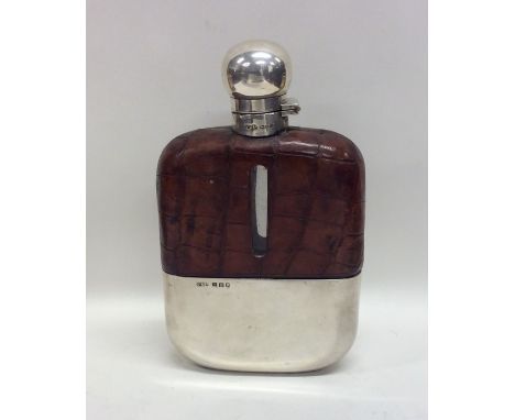 A large heavy Edwardian gent's crocodile skin and silver mounted flask. Approx. 457 grams. Est. £80 - £120.