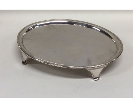 An Old Sheffield plate teapot stand on reeded supports. Est. £15 - £20.