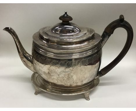 A good quality Georgian silver teapot on stand with bright cut decoration. London. By SG. Approx. 549 grams. Est. £300 - £400