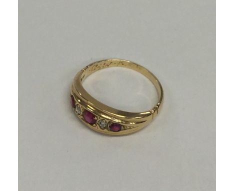 A ruby and diamond ring in gold mount. Approx. 3.1 grams. Est. £60 - £80.