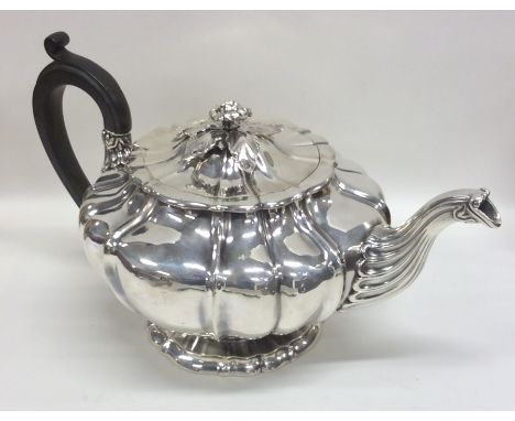 PAUL STORR: A rare melon shaped silver teapot on spreading base, the side crested with a lion to flower finial. London. Appro