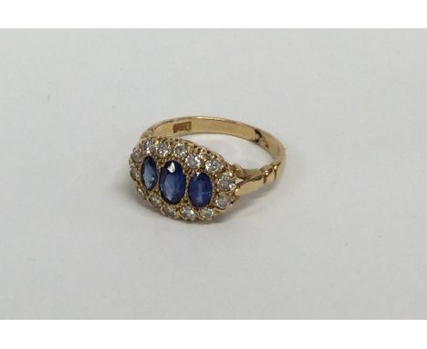 A good Victorian sapphire and diamond cluster ring in 18 carat claw mount. Approx. 3.5 grams. Est. £500 - £600.