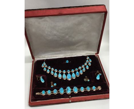 An unusual gold and turquoise fringe necklace together with matching earrings, bracelet and ring contained within a fitted bo