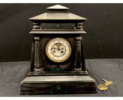A 19th century black marble mantel clock, the architectural case inlaid with malachite, incised, carved, and flanked by flute