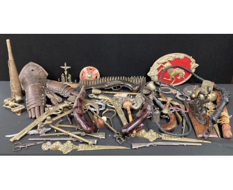 A 19th century brass rank epaulet shoulder piece, replica flintlock pistols, brass anchor, crucifix, Ganesha head wall plaque